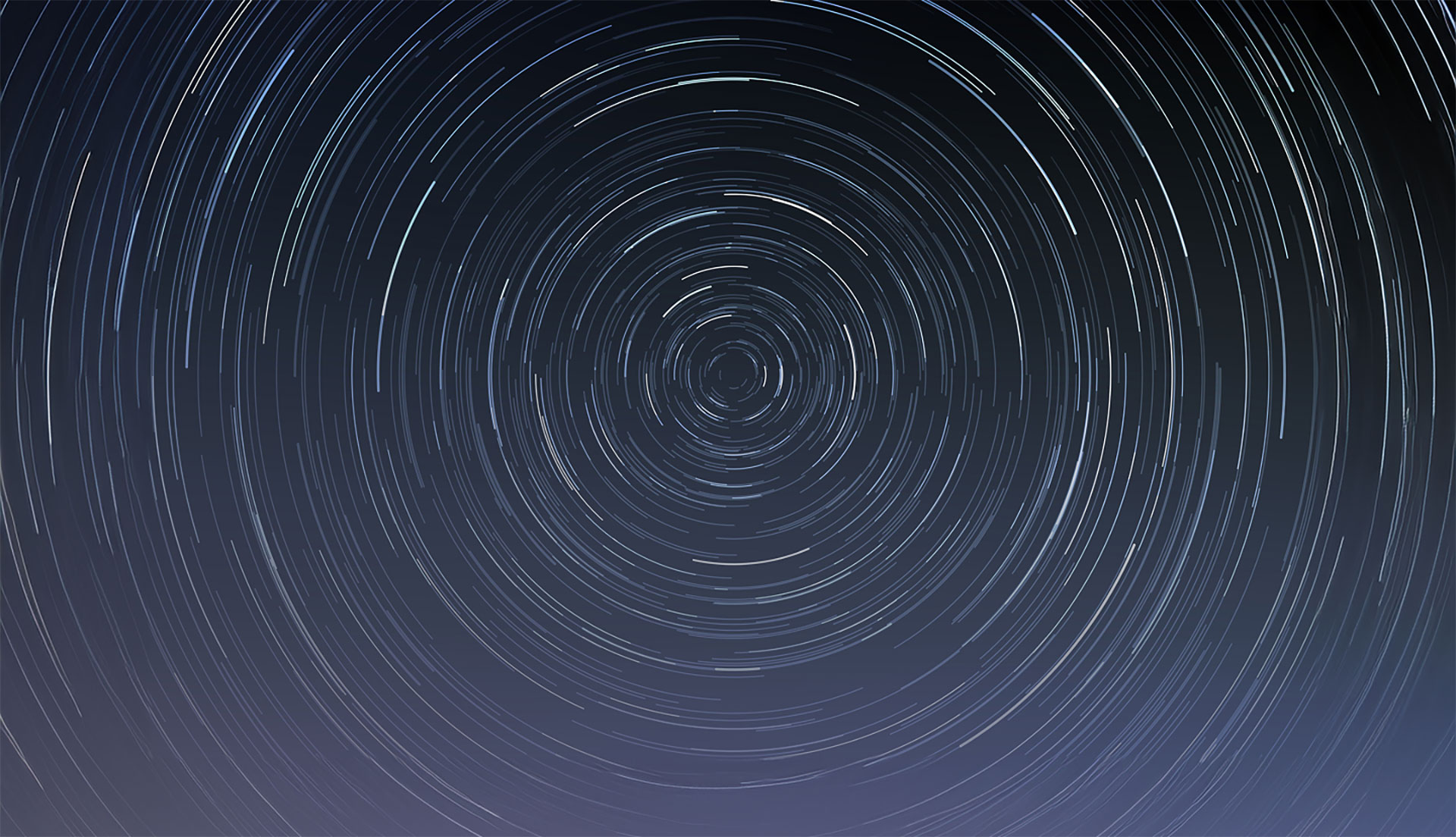 A decorative image with many concentric circles. Each circle is incomplete, and with different intensities.